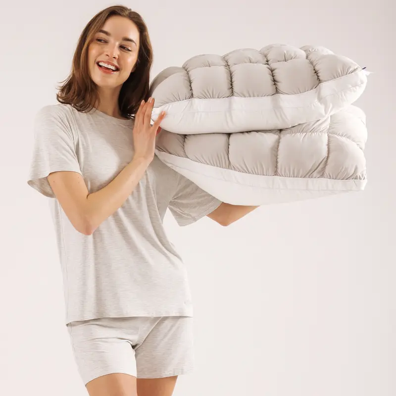 Two gray CloudSoft pillows showing the puff-grid surface