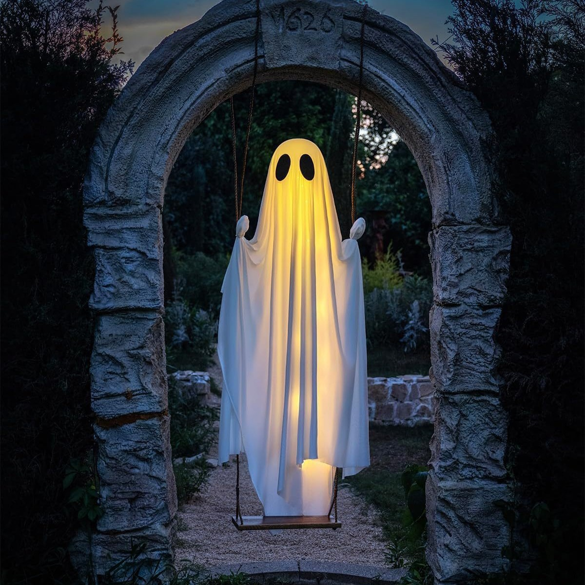 Glowing swing ghost hanging in a stone arch at night